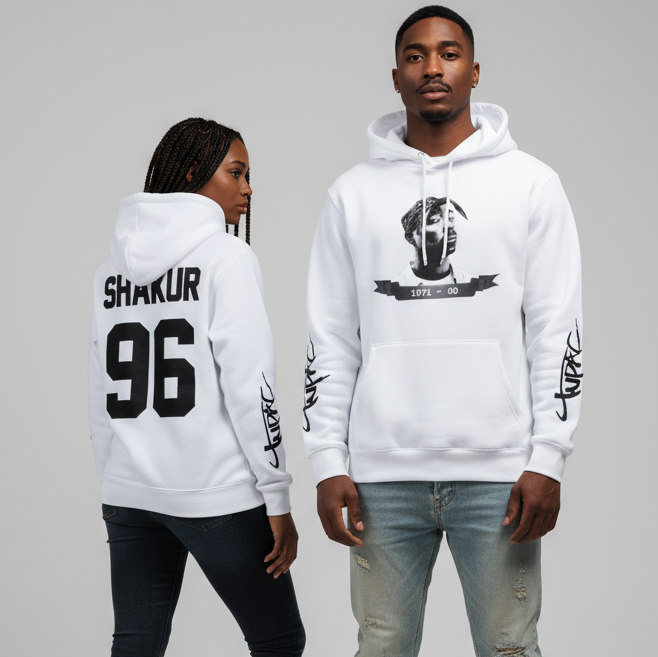 Male and female models wearing matching white Tupac Shakur hoodies, one facing forward showing Tupac portrait print, and one showing back design “Shakur 96”.